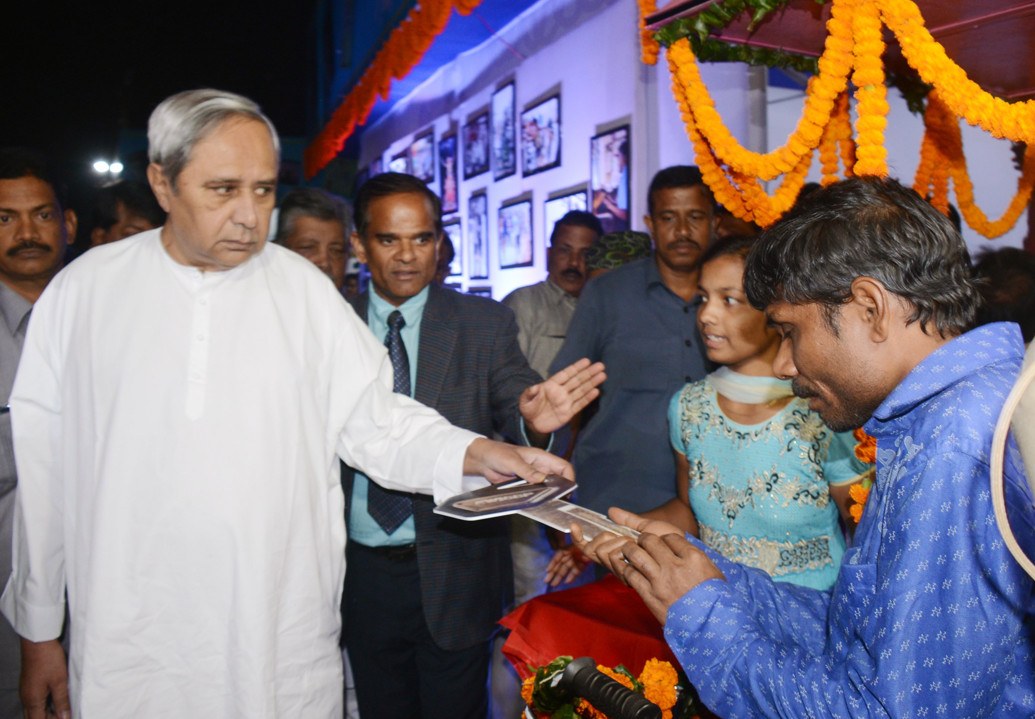 Chief Minister Naveen Patnaik handing over the Key of a Vending Trolley to a differently abled person at Adivasi Exhibition Ground, Unit 1, in Bhubaneswar