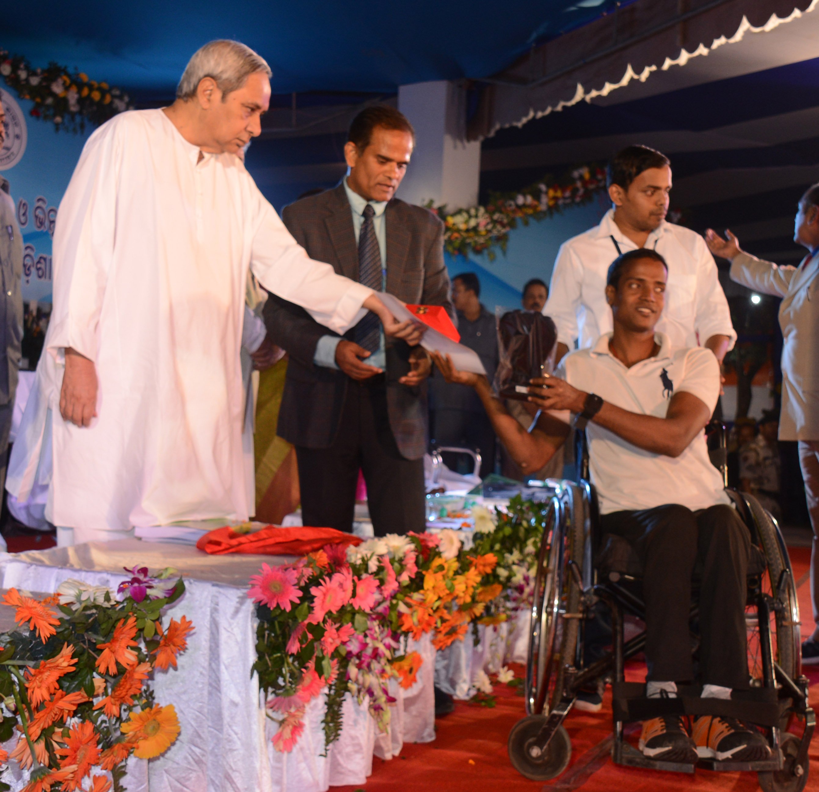 Chief minister Naveen Patnaik giving away awards to differently abled persons and transgenders on International Day for Persons with Disabilities at Adivasi Exhibition Ground, Unit 1 , in Bhubaneswar 