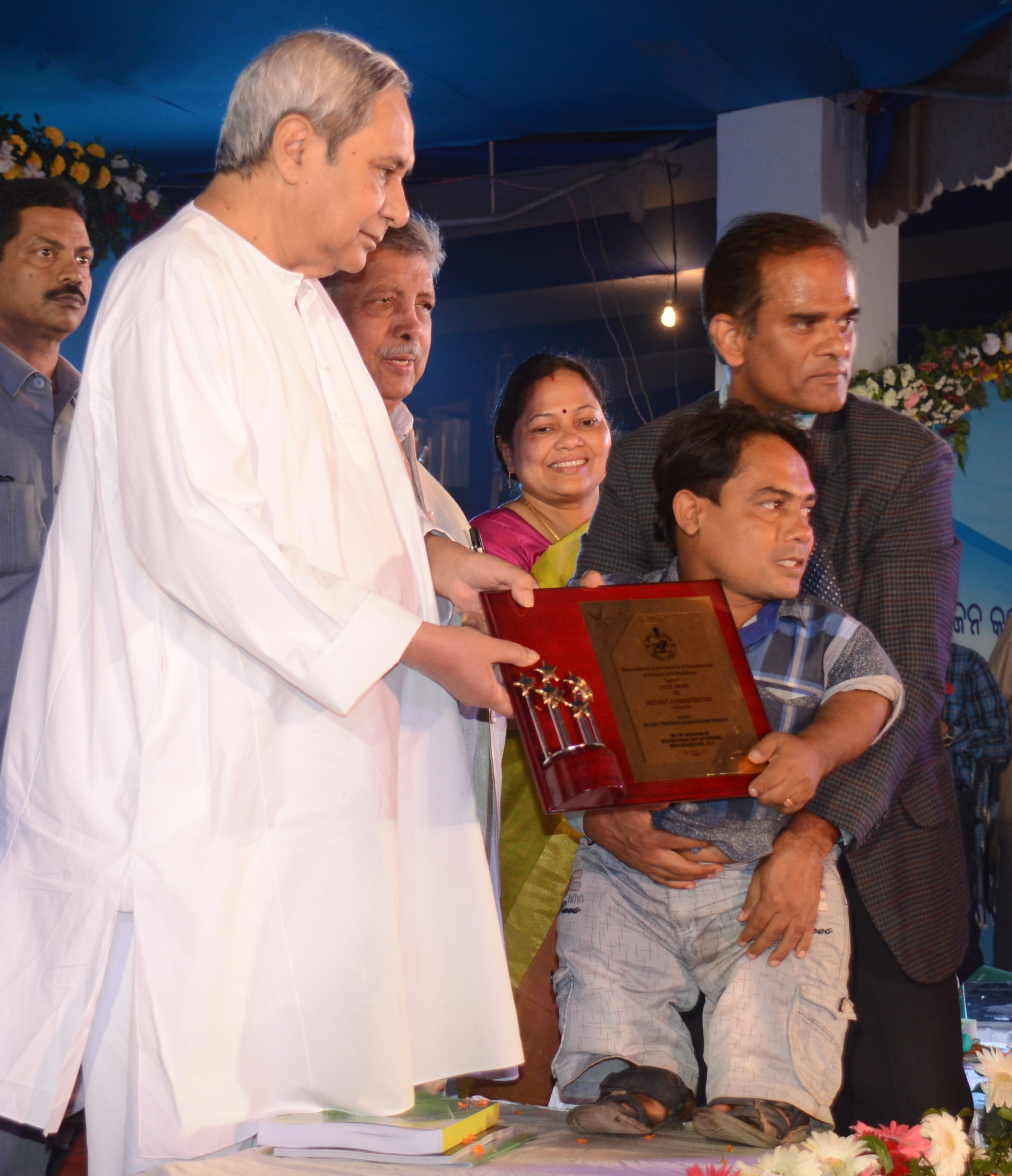 Chief Ministeri Naveen Patnaik giving away awards to differently abled persons and transgenders on International Day for Persons with Disabilities at Adivasi Exhibition Ground, Unit 1, in Bhubaneswar