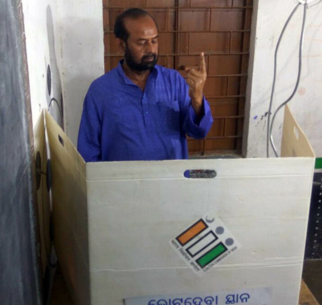 BJP candidate Ashok Panigrahi exercising his franchise at a polling booth in Bijepur Assembly constituency on Saturday.
