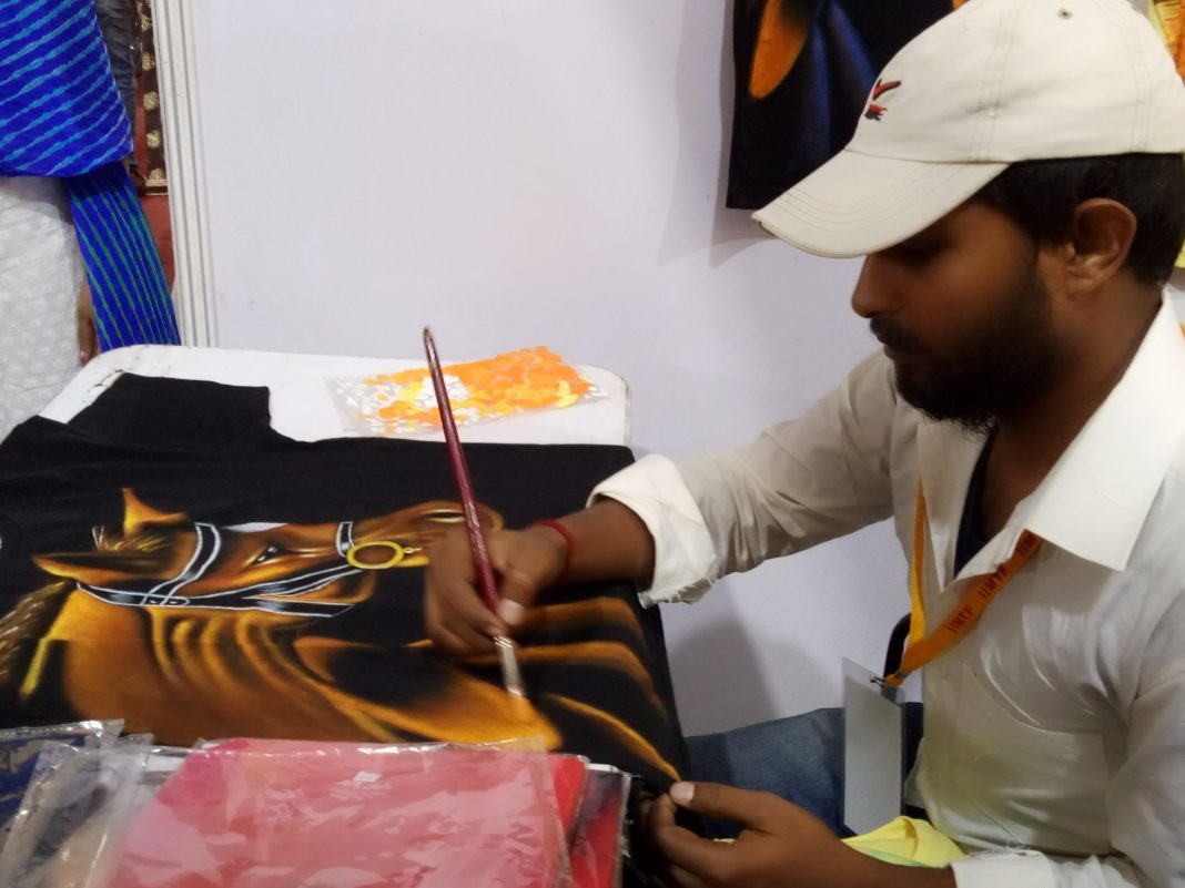 An artist giving finishing touches at the ongoing India International Trade Fair in Bhubaneswar on Saturday.