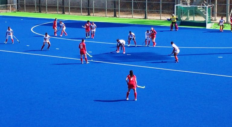 South Korea players prepare to take a free hit against India in their second match