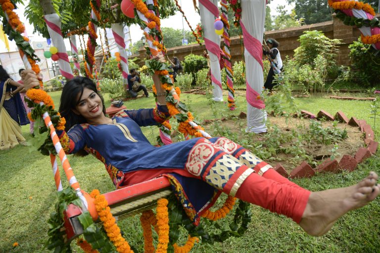 Girls are playing with swings on the eve of three days long 'Raja Festival' - a festival of unmarried girls in Bhubaneswar on Tuesday. During the three days women are given a break from household work and time to play swings and indoor games.Girls decorate themselves with new fashion or traditional Saree Generally various Pithas (traditional sweets) are made of which Podopitha,and Chakuli Pitha are main. Girls play swings tied on tree branches whereas aged ladies play Cards and Ludo.