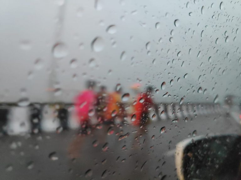 ANNUAL PILGRIMAGE: Bol Bom devotee brave rain on Kathajodi Bridge near Cuttack as they set out for collecting sacred water, which is dispensed as offerings to Lord Shiva at temples every Monday during the holy month of Shravana. OB Photograph