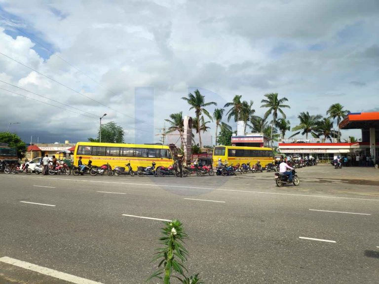 LONG QUEUE: People line up for pollution control certificates of their vehicles at a petrol filling station in Bhubaneswar on Saturday. Photograph: Suprakash Mishra.