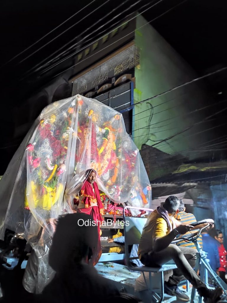 Shower Safety: A polythene covered Durga idol being taken for immersion in rain drenched Cuttack on Wednesday night. Photograph: Suprakash Mishra.