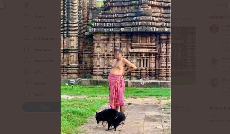 man walking pet dog inside temple in bhubaneswar